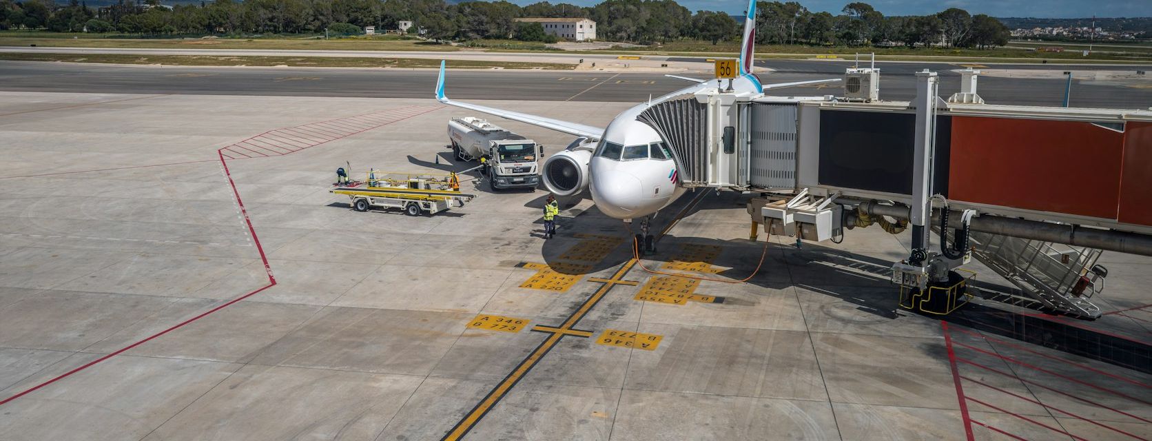 Passenger jet connected to a jet bridge on an airport apron