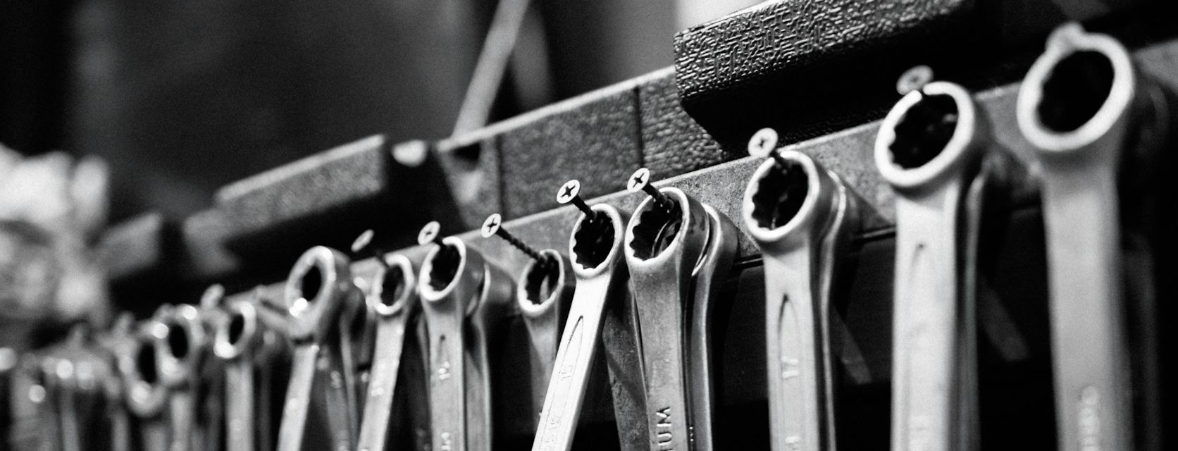Rows of spanners hanging on a workshop rail