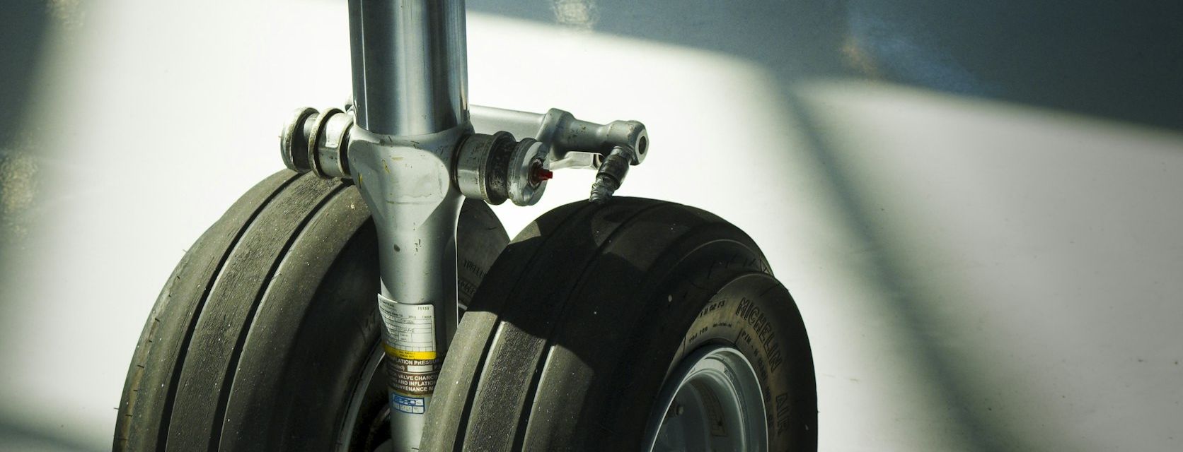 Close-up of an aircraft landing-gear strut and wheels