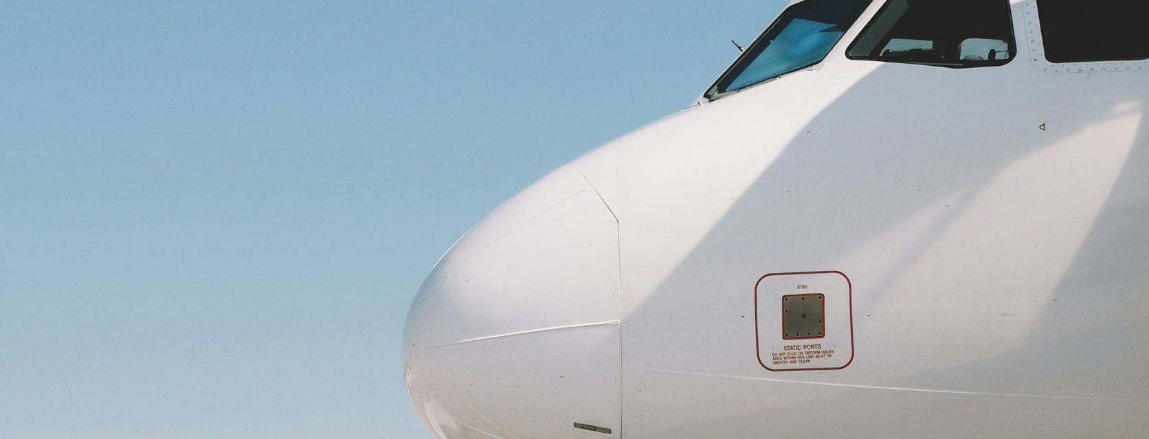 Nose and cockpit windows of a narrow-body airliner